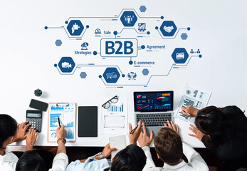 A diverse business team discusses B2B e-commerce strategies using digital tools and data analysis....