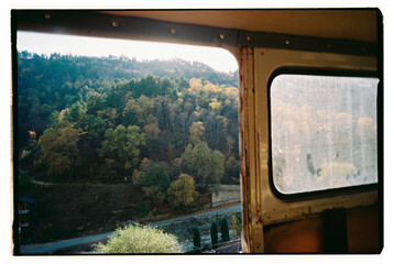 View from a car window over autumn forest landscape