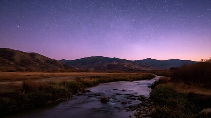 A serene twilight scene unfolds with a vast purple sky full of stars above rolling mountains and a calm river winding through a dry valley