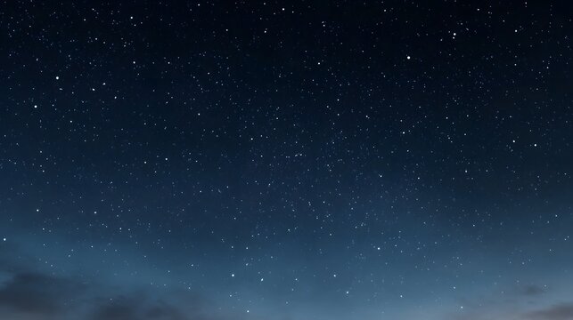 A vast dark blue night sky is filled with countless bright stars and subtle atmospheric haze