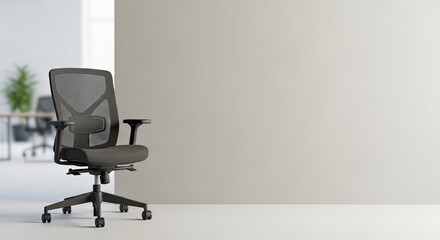 A black office chair with mesh backrest and seat in a spacious, modern office with white walls and a green plant in the background.
