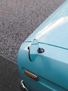 Close-up of round mirror on blue vintage car