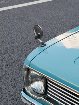 Close-up of round mirror on blue vintage car