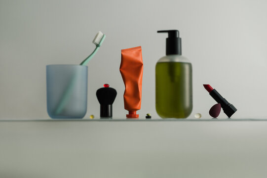 Minimal still life with self care products on bathroom shelf