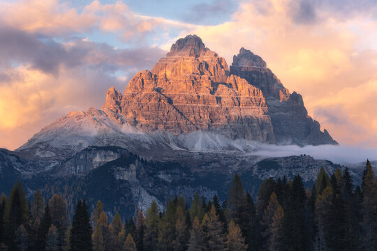A mountain in the clouds and sunset light