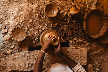 Potter Shaping Clay on Wheel