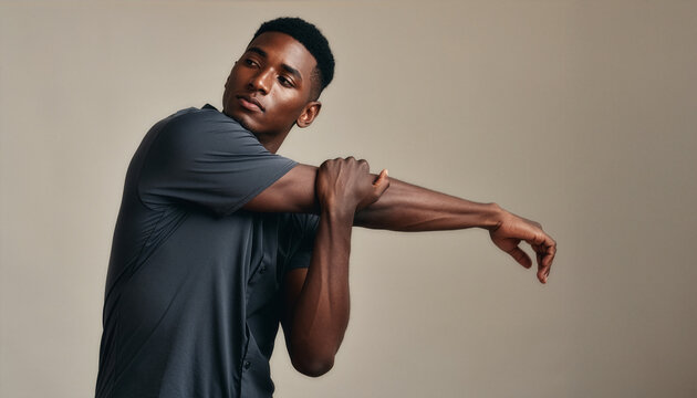 Young Black man stretches arm to release tension and stress