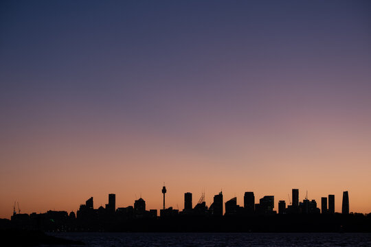 Silhouetted Sydney Skyline Against a Gradient Sunset