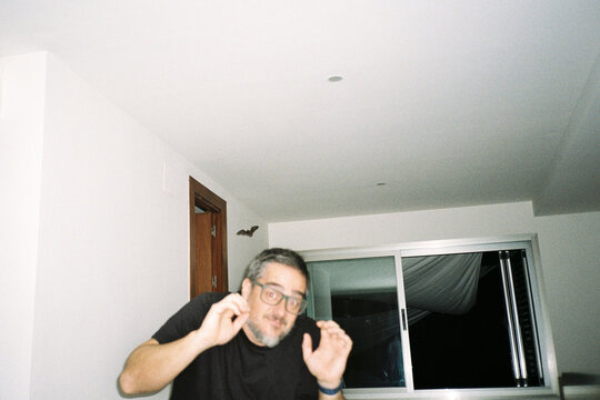 Man Reacting to Bat Indoors
