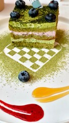 Blueberry Matcha Cake with Vibrant Green Tea Layers and Fresh Berry Topping