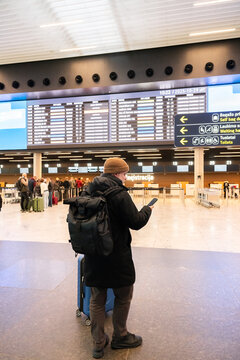 Traveler Checking Flight Information at the Airport 