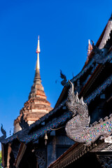 Ancient Wat Lok Moli temple with traditional Lanna architecture in Chiang Mai, Thailand. Beautiful blue sky, historic pagoda, and cultural heritage