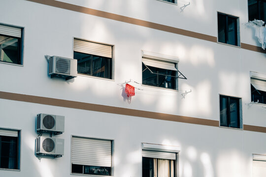Building Facade With Air Conditioning Units and Laundry Drying Outside
