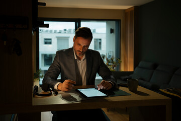 Businessman working networking remotely from home office
