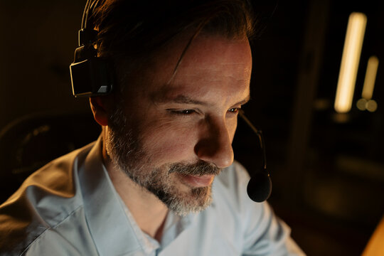 Call center agent wearing headset working night shift
