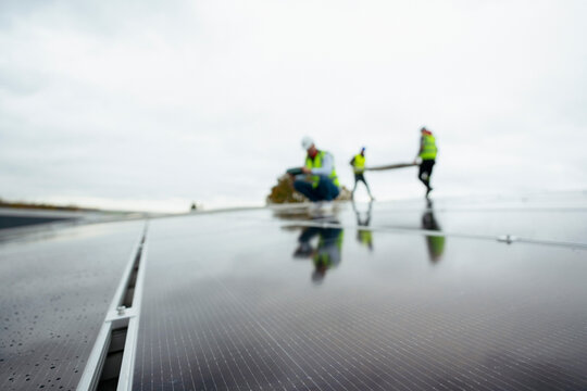 Solar pv modules reflecting energy workers installing renewable power
