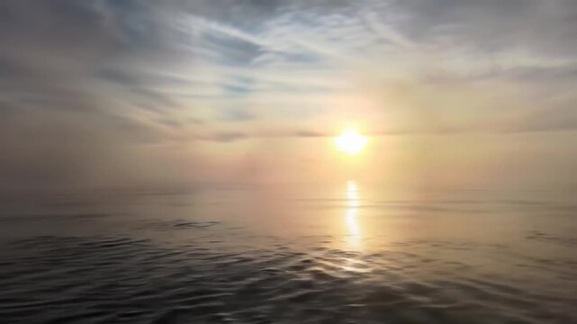 Tranquil ocean scene with sunlight reflecting on the water at sunset