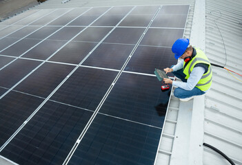 Technician working on solar panels, checking renewable energy system
