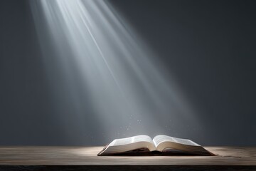 Open Book Illuminated by Rays of Light on a Textured Wooden Surface Against a Dark Background