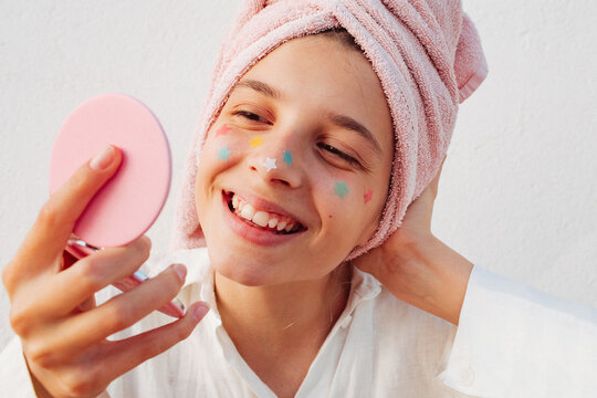 A pre-teen stuck many pimple patches in the shape of colorful stars