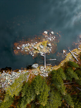 Serene View of a Rocky Shoreline Beside Calm Water at Dawn