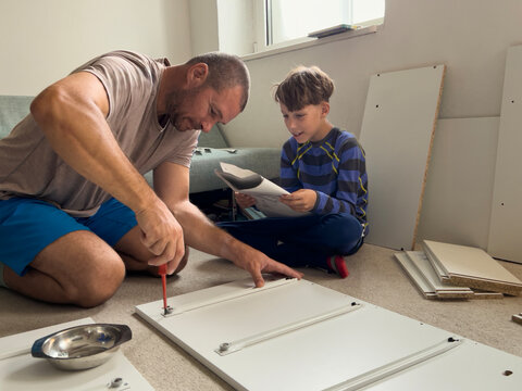 Father and Son Building Furniture Together in a Cozy Living Room