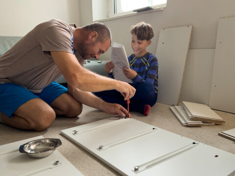 Father and Son spend time together while assembling Furniture