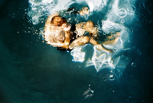 Abstract man underwater in a pool