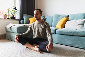 Mindful Man Meditating in Living Room