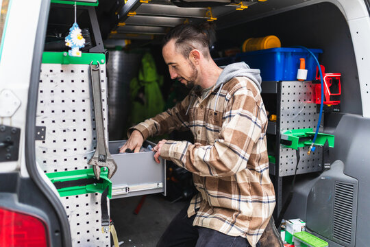Service Technician Checking System using Laptop in Van