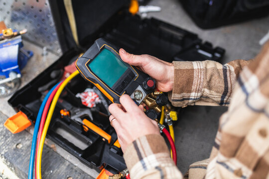 Professional Technician Working with Tools and Service Van