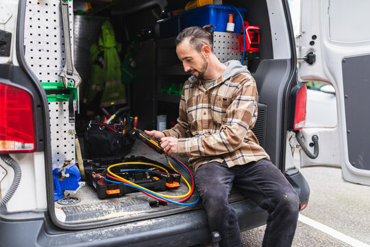 Professional Technician Working with Tools and Service Van