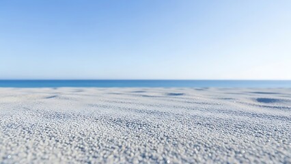 Serene beach scene showcasing white sand and a calm blue ocean horizon