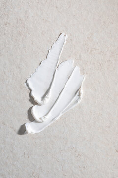 White Cream Spread on a Textured Surface During Daylight Hours