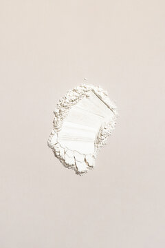 Bright White Powder Scattered on a Light Surface, Showing Texture