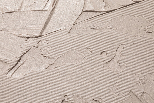 Textured Plaster Surface With Intricate Patterns and Shades