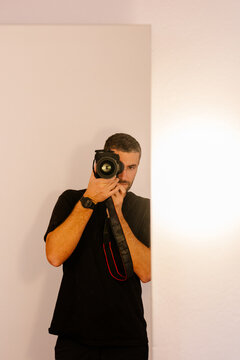 Self-portrait of a photographer using a professional camera