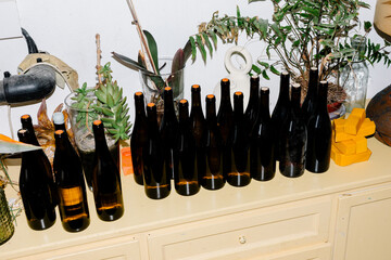 Medium shot lit by flash of a batch of freshly sealed wine bottles