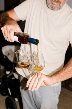 Bearded man serving glasses of wine during a tasting