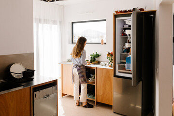 Woman spending a calm day indoors as she prepares a nutritious dish