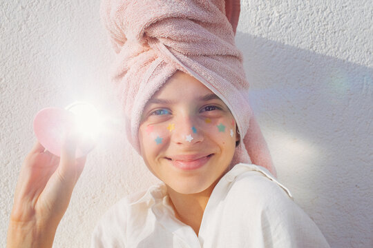 A pre-teen stuck many pimple patches in the shape of colorful stars