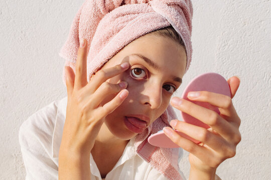 A pre-teen girl stuck many pimple patches in the shape of colorful stars