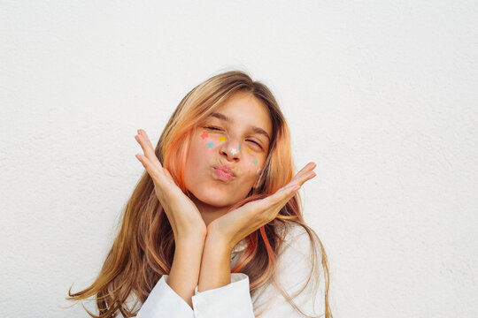 A pre-teen stuck many pimple patches in the shape of colorful stars