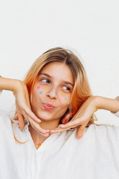 A pre-teen stuck many pimple patches in the shape of colorful stars