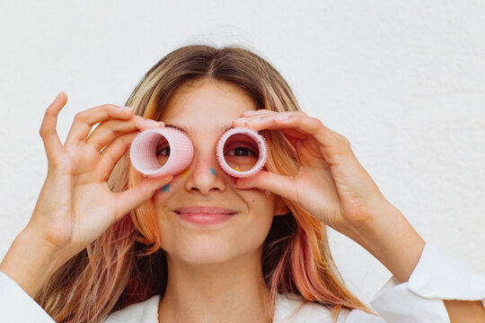 A girl stuck lots of pimple patches and put in curlers.
