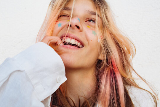 A pre-teen stuck many pimple patches in the shape of colorful stars