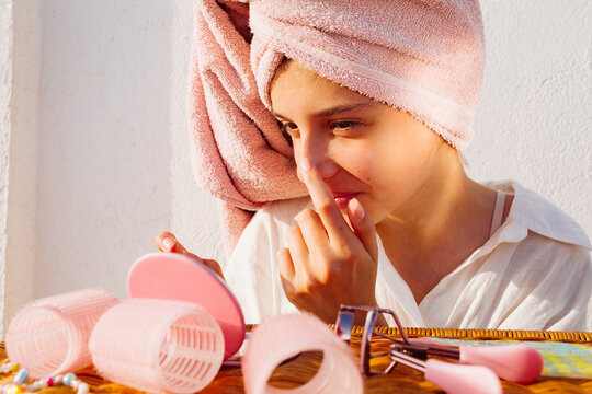 A pre-teen stuck many pimple patches in the shape of colorful stars