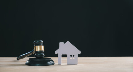 Foreclosure house property law concept, judge gavel beside small home model, depicts legal action for debt sale auction or division, illustrating bankruptcy process and estate proceedings