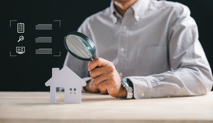 Man performs real estate home appraisal, using magnifying glass to appraise property details for thorough valuation, comprehensive search for prospective buyers or diligent inspector