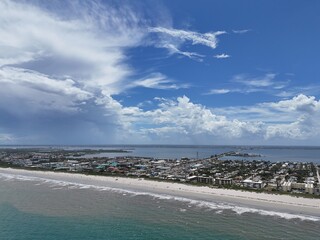 Aerial view of Cape Canaveral coastline with sandy beach, Atlantic Ocean, coastal city and cloudy sky. g.